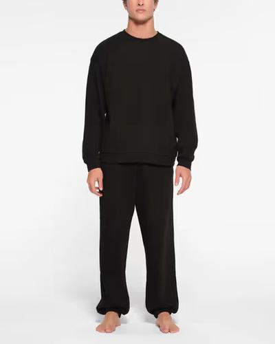 A man wearing Skims classic crewneck t-shirt