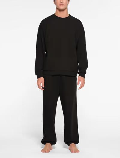 A man wearing Skims classic crewneck t-shirt