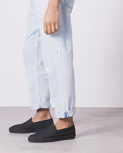 A man wearing Castañer black shoes