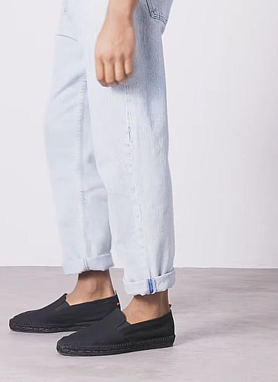 A man wearing Castañer black shoes