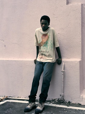 A man wearing Piet Sau Paulo printed t-shirt