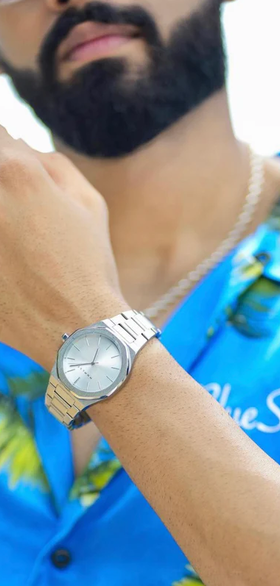 A man wearing mnmlst silver wtach