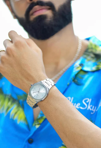 A man wearing mnmlst silver wtach