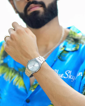 A man wearing mnmlst silver wtach