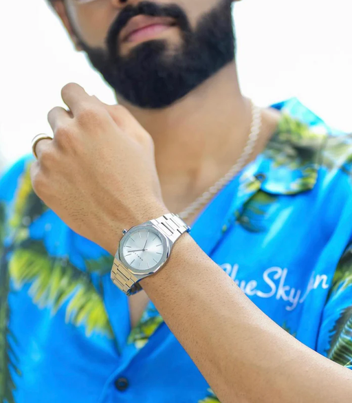 A man wearing mnmlst silver wtach