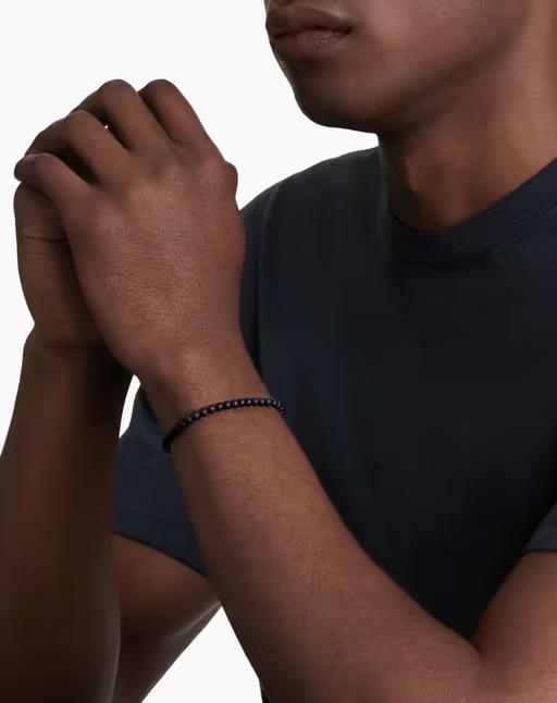 A man wearing David Yurman spiritual beads bracelet