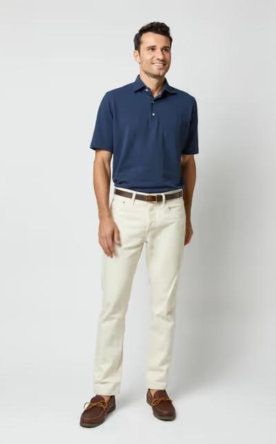 A man wearing Sid Mashburn navy short-sleeved polo