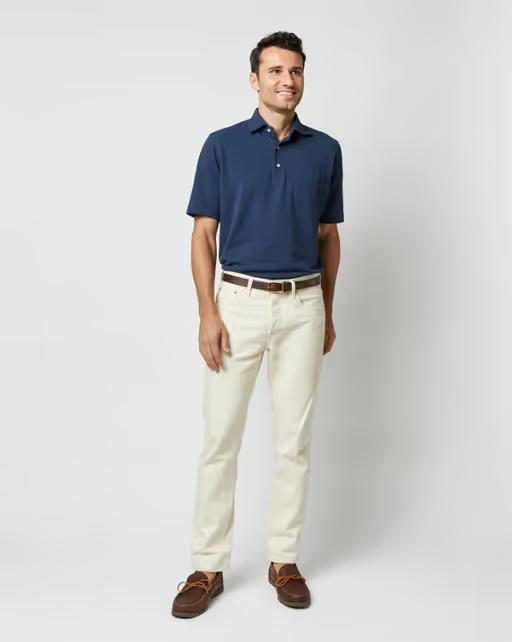 A man wearing Sid Mashburn navy short-sleeved polo