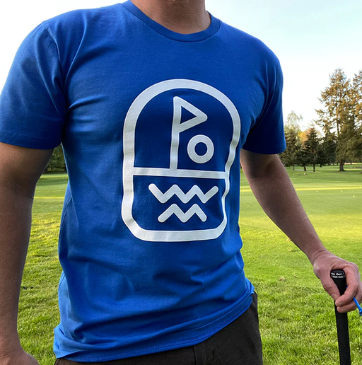 A man wearing Clinch Golf blue clinch 'flagstick' ss tee