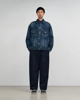 A man wearing Graphpaper Kyoto selvage denim trucker jacket