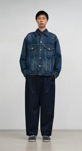 A man wearing Graphpaper Kyoto selvage denim trucker jacket