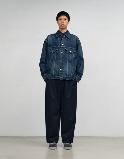A man wearing Graphpaper Kyoto selvage denim trucker jacket