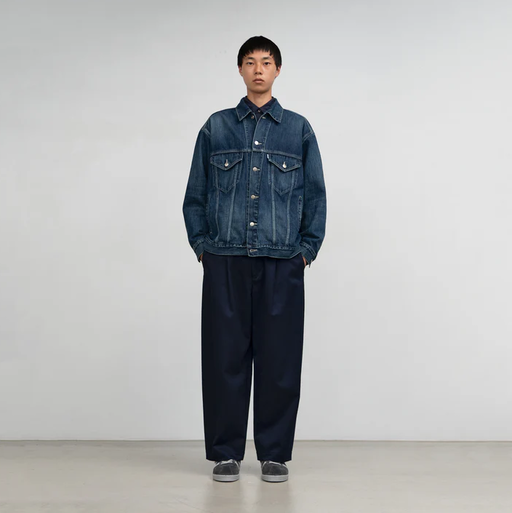 A man wearing Graphpaper Kyoto selvage denim trucker jacket