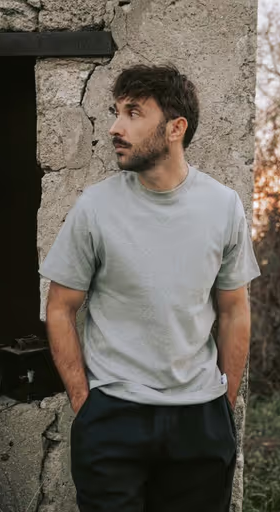 A man wearing a grey Bleu de chauffe t-shirt and navy blue pants