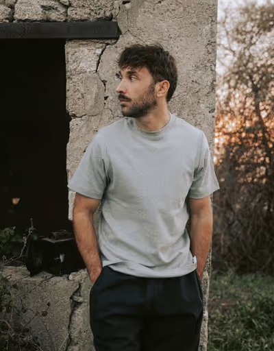 A man wearing a grey Bleu de chauffe t-shirt and navy blue pants