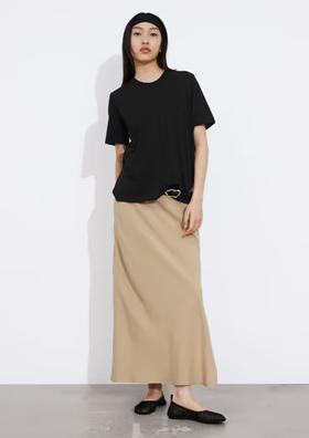 A woman wearing & Other Stories black crewneck t-shirt
