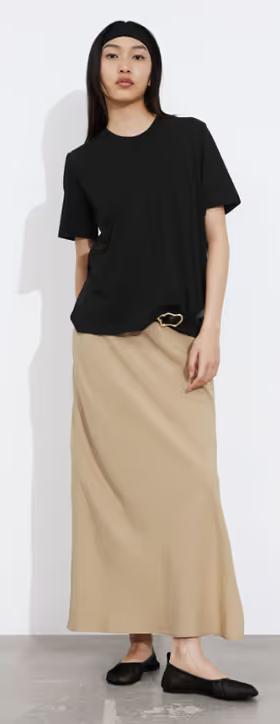 A woman wearing & Other Stories black crewneck t-shirt