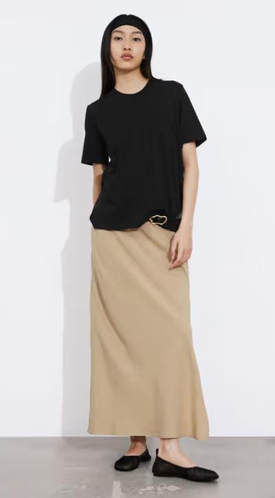 A woman wearing & Other Stories black crewneck t-shirt