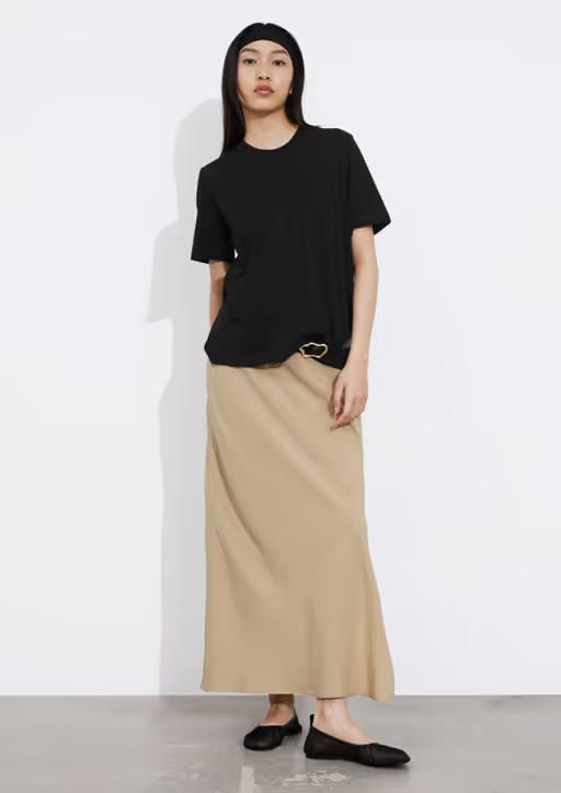 A woman wearing & Other Stories black crewneck t-shirt