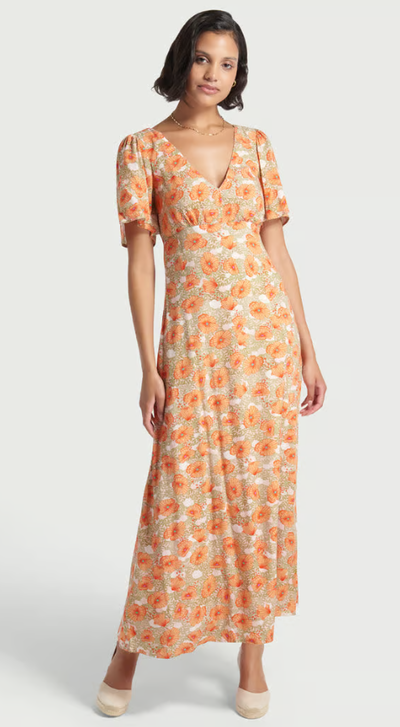 A woman wearing Modcloth floral meadow whisper maxi dress