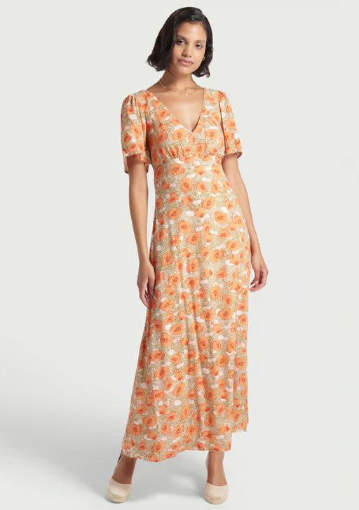 A woman wearing Modcloth floral meadow whisper maxi dress