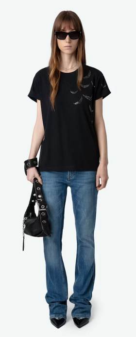 A woman wearing Zadig & Voltaire stone color anya diamante wings t-shirt