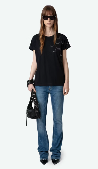 A woman wearing Zadig & Voltaire stone color anya diamante wings t-shirt
