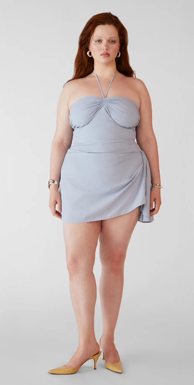 A woman wearing Orseund Iris bardot mini dress - parisian blue