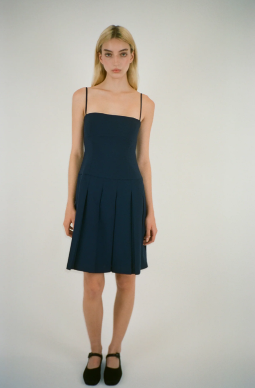 A woman wearing Sandy Liang roo dress in navy