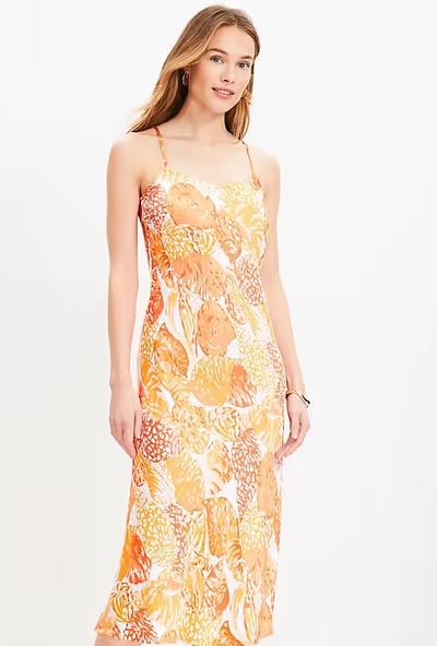 A woman wearing Loft baked gold shell bias midi slip dress