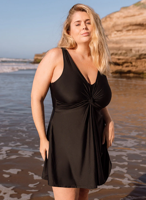 A woman wearing Shapermint shapermint essentials swim knot-front swim dress - black