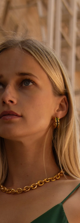 A woman wearing Soko anga inlay hoop earrings