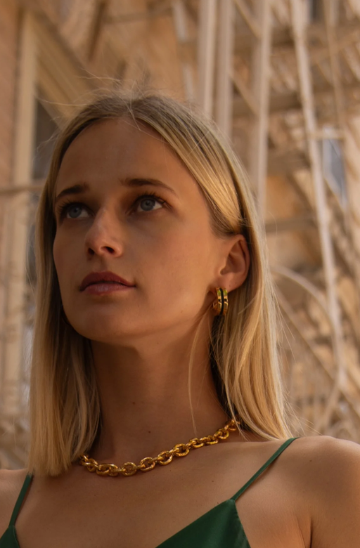 A woman wearing Soko anga inlay hoop earrings