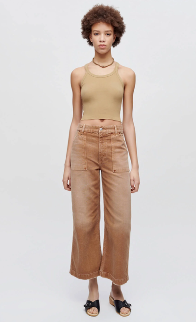 A woman wearing Re/Done sand color hanes cropped ribbed tank
