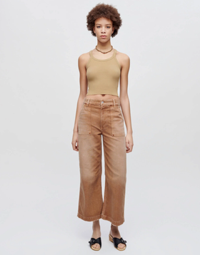 A woman wearing Re/Done sand color hanes cropped ribbed tank