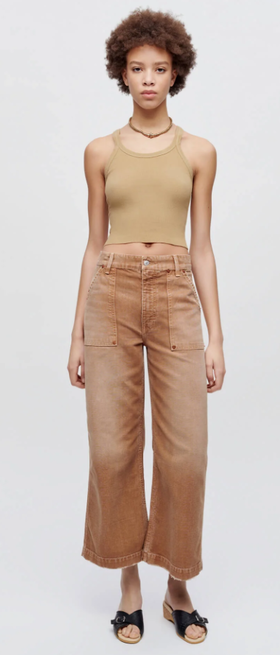 A woman wearing Re/Done sand color hanes cropped ribbed tank