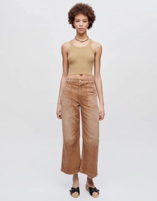 A woman wearing Re/Done sand color hanes cropped ribbed tank
