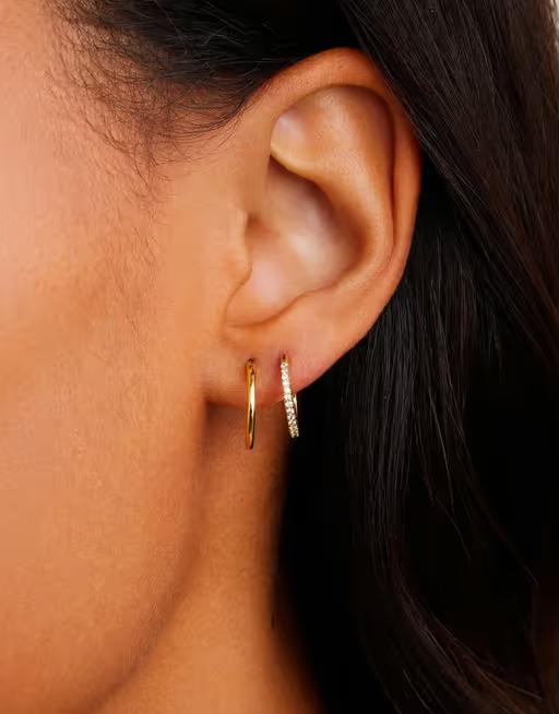 A woman wearing Gorjana classic huggie set earrings