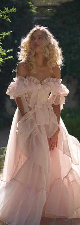 A woman wearing selkie the confection carriage gown