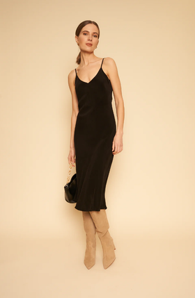 A woman wearing Whimsy + Row freya slip dress in black