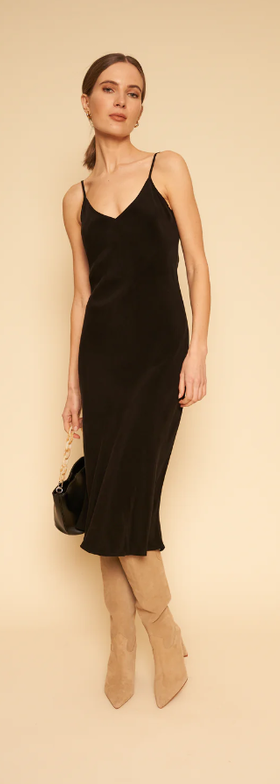 A woman wearing Whimsy + Row freya slip dress in black
