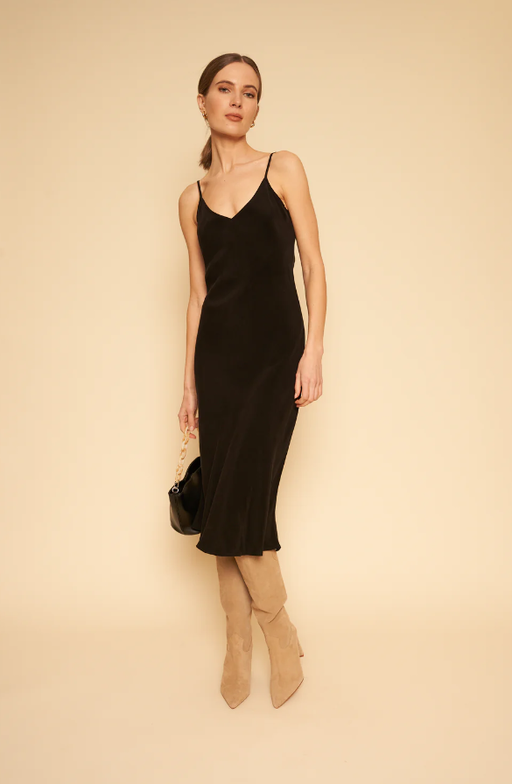 A woman wearing Whimsy + Row freya slip dress in black