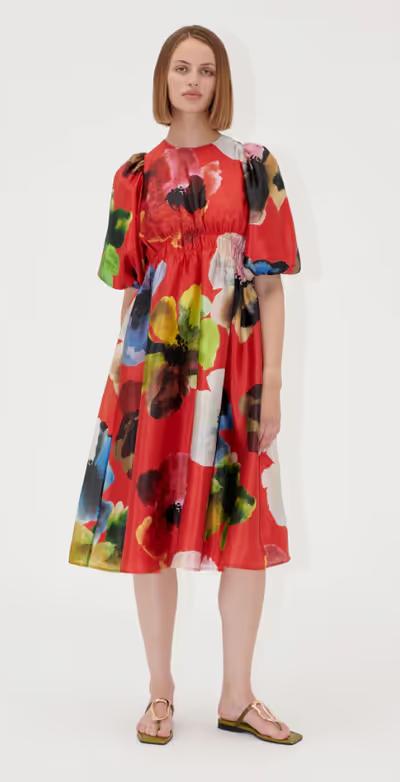 A woman wearing Stine Goya elasticated waist midi dress - bloom in red