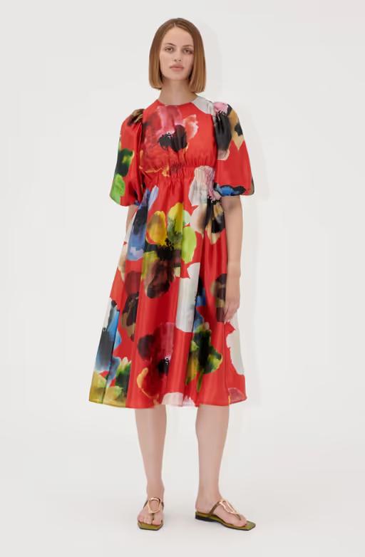 A woman wearing Stine Goya elasticated waist midi dress - bloom in red