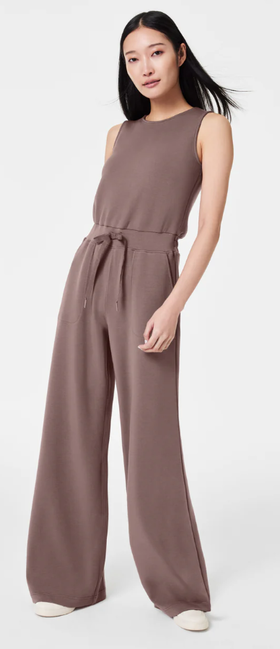 A woman wearing Spanx smoke color airessentials jumpsuit
