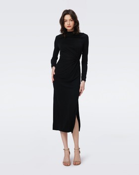 A woman wearing DVF black sonja dress