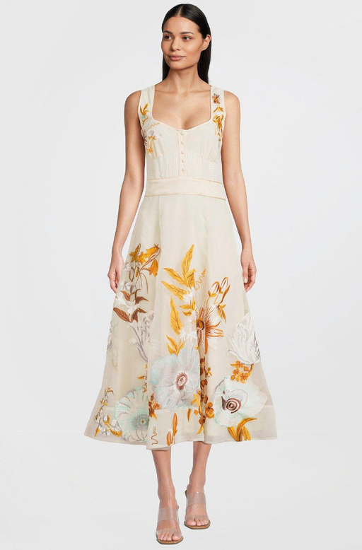 A woman wearing karen millen cream color botanical embroidery organdie strappy midi dress