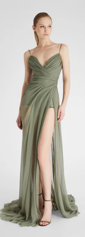 A woman wearing Ermanno Scervino green long silk dress with slit