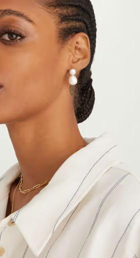 A woman wearing Mejuri bold pearl drop earrings