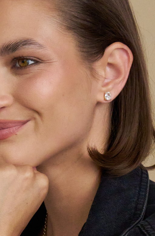 A woman wearing Stella & Dot inheritance oval studs earrings
